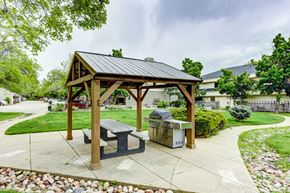 Boulder apartment for rent - A wooden pavilion with a black roof and a picnic table in front of a grassy area.