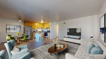 Englewood apartment for rent - A modern living room with a blue sofa and a coffee table.