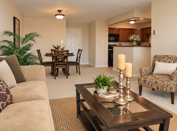 Denver apartment for rent - A living room with a brown couch, a wooden coffee table, and a dining table with chairs.