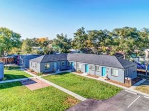 Wheat Ridge apartment for rent - A row of houses with blue doors and green lawns.