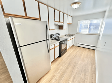 Lakewood apartment for rent - A kitchen with a refrigerator, oven, and microwave.