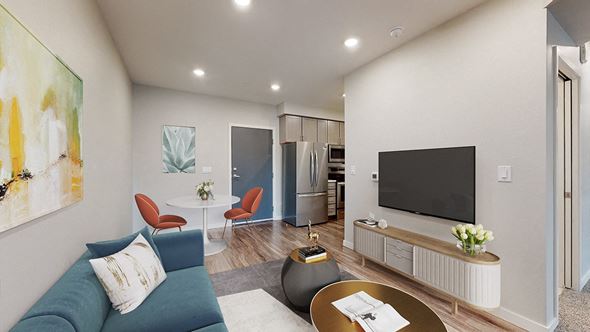 Denver apartment for rent - a living room with a blue couch and a tv