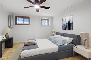 Denver apartment for rent - a bedroom with a large bed and a ceiling fan