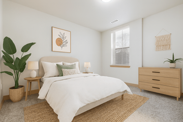 Denver apartment for rent - A bedroom with a large bed, a side table with a lamp, and a dresser with a plant on top.