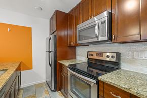 Boulder apartment for rent - A kitchen with a stove top oven and a microwave above it.