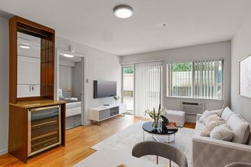 Boulder apartment for rent - A modern living room with a grey couch and a wooden cabinet.