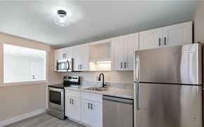 Denver apartment for rent - A kitchen with a stainless steel refrigerator, oven, and microwave.
