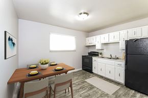 Arvada apartment for rent - A kitchen with black appliances and white cabinets.