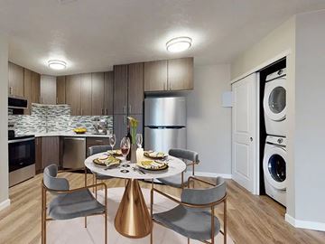 Aurora apartment for rent - A modern kitchen with a dining table set for two.