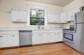 Boulder apartment for rent - A kitchen with white cabinets and a window.