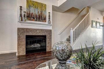 Aurora apartment for rent - A living room with a fireplace and a painting above it.