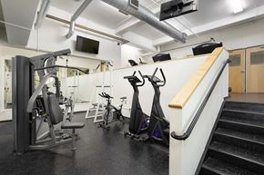 Denver apartment for rent - A gym with a variety of equipment including a treadmill, stationary bike, and weight bench.