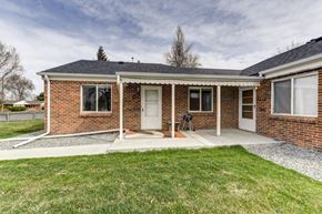 Denver apartment for rent - A brick house with a white door and windows.