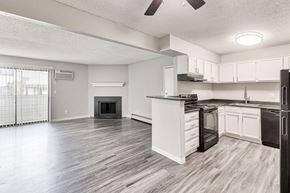 Denver apartment for rent - A modern kitchen with white cabinets and a black stove top oven.at Miramar Apartments, Denver Colorado