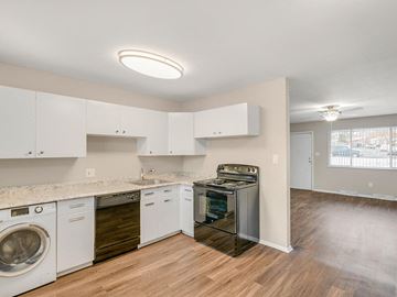 Denver apartment for rent - A kitchen with white cabinets and wooden floors.