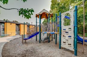 Greeley apartment for rent - a playground with a slide and a swing set