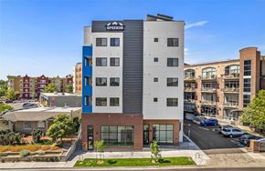 Denver apartment for rent - A modern building with the sign SPEER26 on the top.