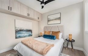 Denver apartment for rent - A bedroom with a bed, a ceiling fan, and a painting on the wall.