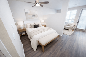 Denver apartment for rent - A bedroom with a large bed and a ceiling fan.