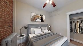 Denver apartment for rent - a bedroom with a bed and a closet