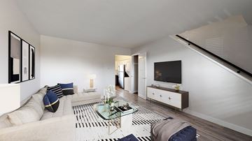 Englewood apartment for rent - A modern living room with a glass coffee table and a white sofa.