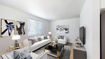 Arvada apartment for rent - A living room with a white couch and a black coffee table.