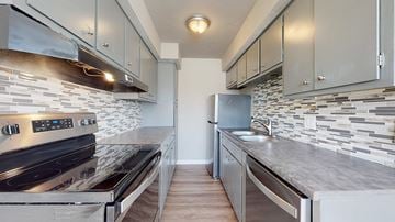 Littleton apartment for rent - A modern kitchen with a stove top oven and a refrigerator.