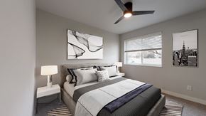Arvada apartment for rent - A bedroom with a large bed and a ceiling fan.