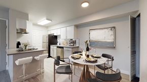 Arvada apartment for rent - A modern kitchen with a dining table set for two.