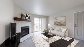 Arvada apartment for rent - A living room with a fireplace and a couch.