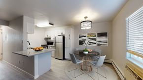 Arvada apartment for rent - A modern kitchen with a dining table and chairs.
