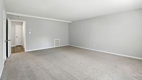 Bethlehem apartment for rent - A sparsely furnished room with a carpeted floor and white walls.