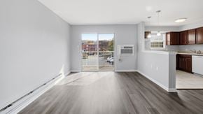 Bethlehem apartment for rent - A spacious room with wooden flooring and white walls.
