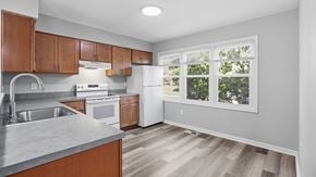 Bethlehem apartment for rent - A kitchen with wooden cabinets and a white fridge.