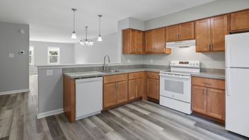 Bethlehem apartment for rent - A kitchen with wooden cabinets and white appliances.