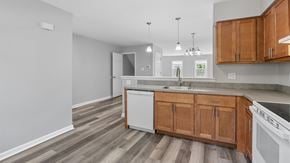 Bethlehem apartment for rent - A kitchen with wooden cabinets and a white dishwasher.