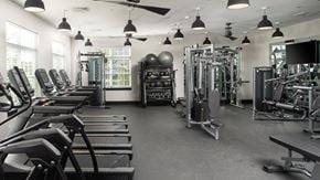 Bordentown apartment for rent - a gym with cardio equipment and weights on the floor