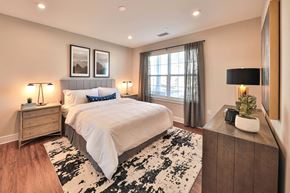 Hillsborough apartment for rent - a bedroom with a bed and a dresser and a window