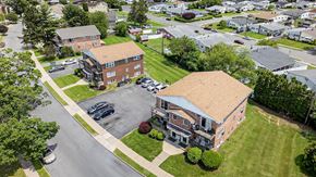 Bethlehem apartment for rent - A large building with a parking lot in front of it.