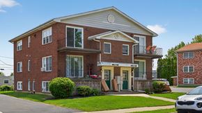 Bethlehem apartment for rent - A red brick house with a white roof and a balcony on the second floor.