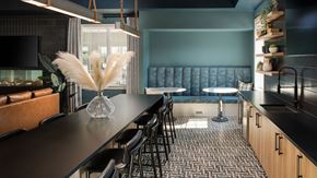 Whitehouse Station apartment for rent - a dining room with a long table and chairs and a blue couch