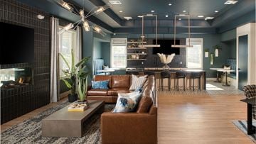 Whitehouse Station apartment for rent - a living room and kitchen with blue walls and leather furniture