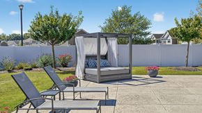 York townhouse for rent - A patio with a hot tub and chairs.