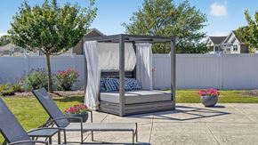 York apartment for rent - A hot tub is surrounded by a white fence and a few plants.