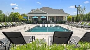 Whitehouse Station apartment for rent - a pool with lounge chairs and a building in the background
