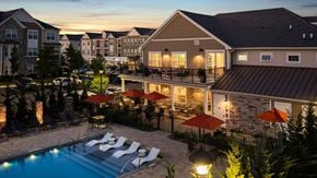 Hillsborough apartment for rent - A pool surrounded by lounge chairs and umbrellas at a resort.