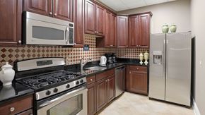 Whitehall apartment for rent - Community center kitchen with brown cabinets and a black stove top.