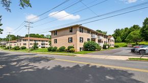 Bethlehem apartment for rent - A street view of a residential area with houses and cars.