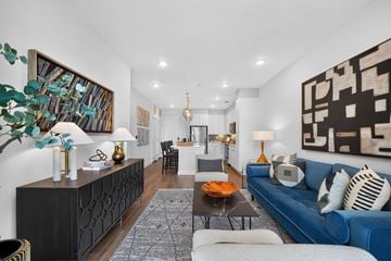 Jacksonville apartment for rent - A living room with a blue couch and a black cabinet.