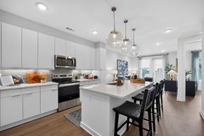 Jacksonville apartment for rent - A modern kitchen with white cabinets and a large island.